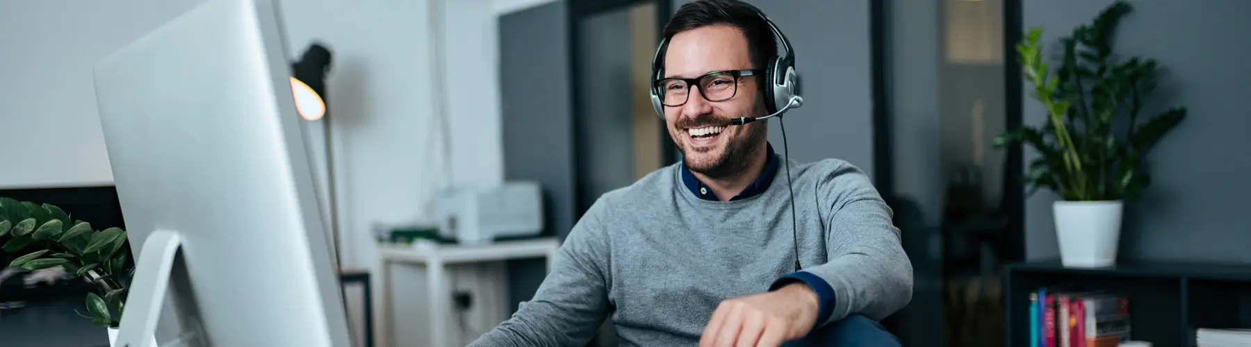 Friendly representative with headset works with customer over the phone